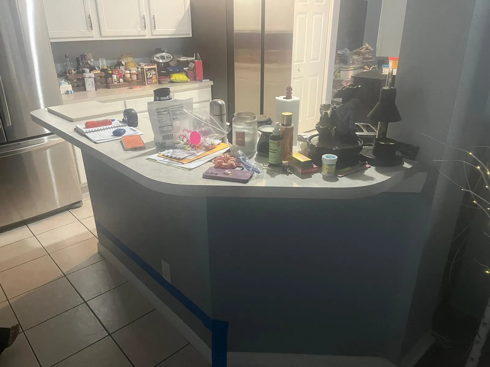 Kitchen peninsula with laminate countertop before the remodel